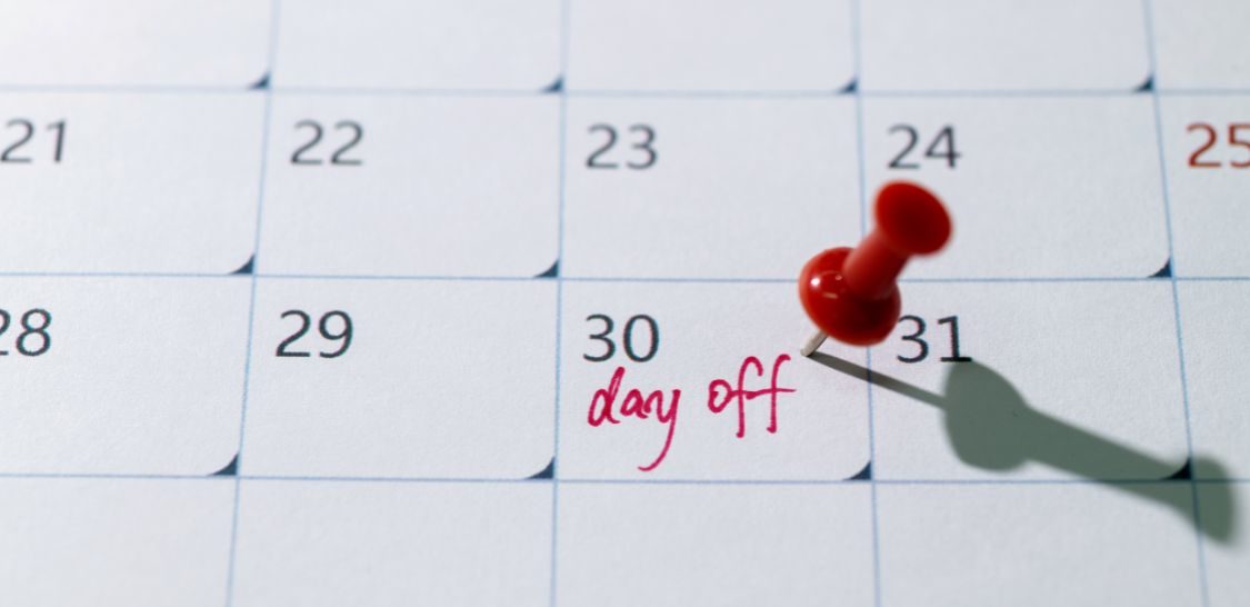 A calendar with a pin in the day 30 and writing that says "day off"