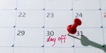 A calendar with a pin in the day 30 and writing that says "day off"