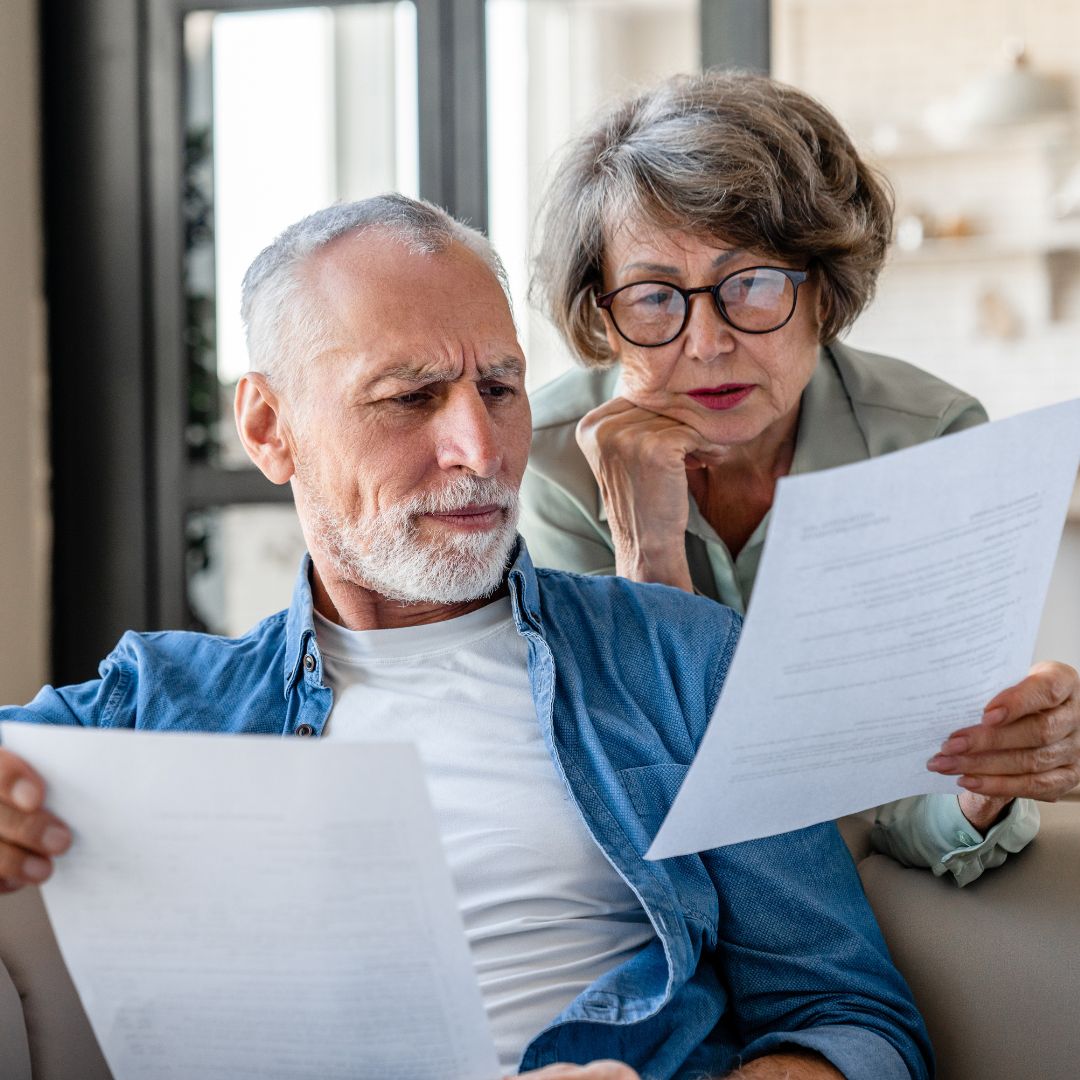 man and women looking at two papers