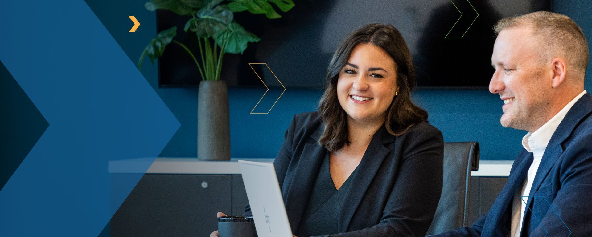 RKL employees at a table smiling with RKL branding