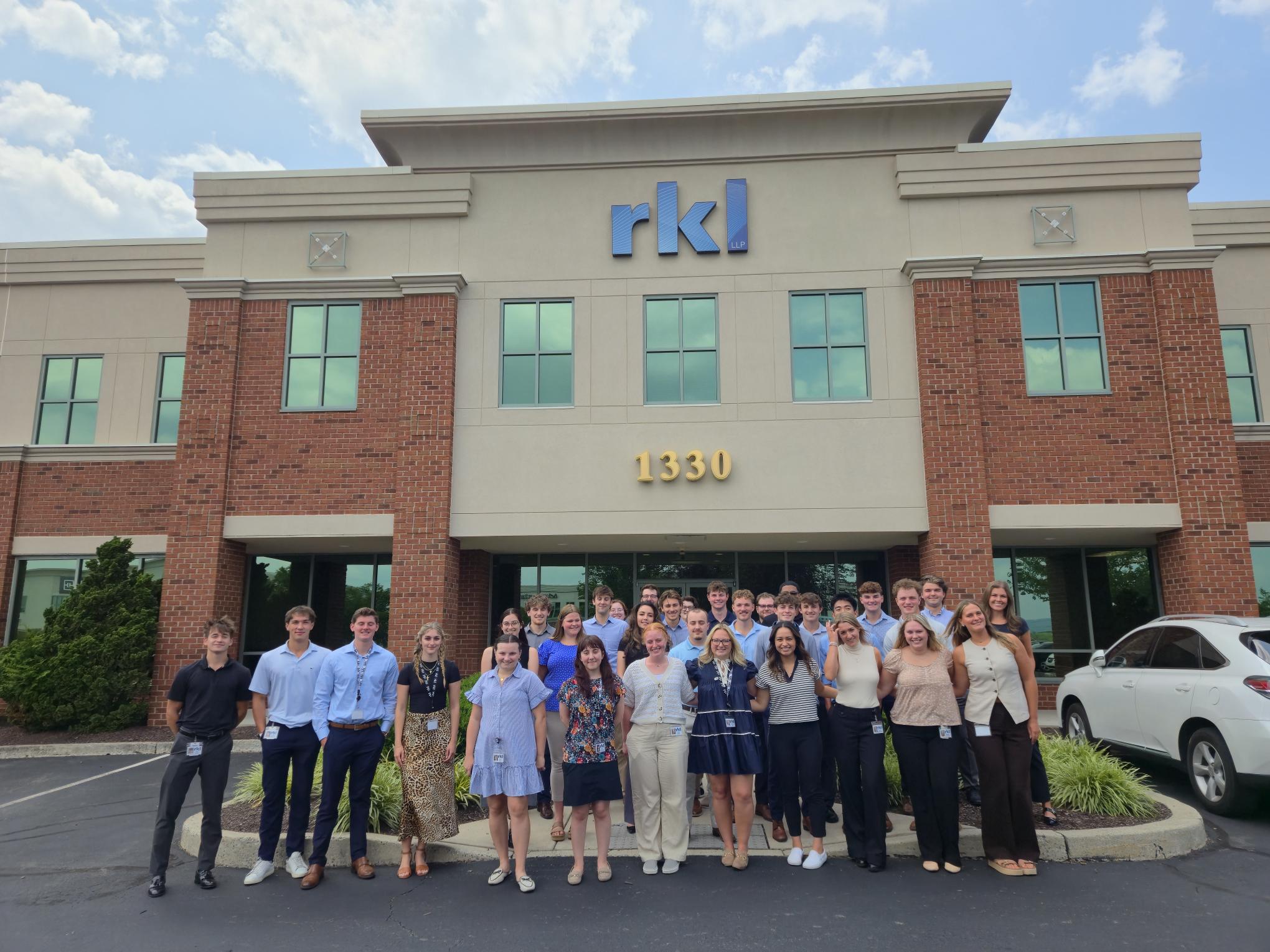 RKL interns posing in front of RKL building