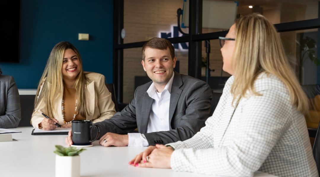 Professionals meeting around a conference table in a modern office