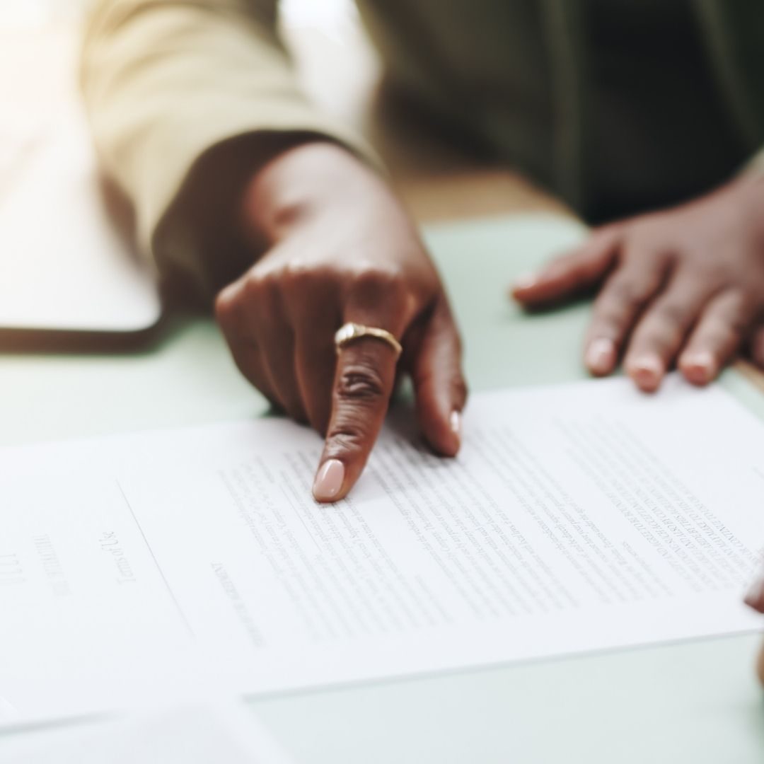 Tax professional pointing to details in a financial document during a consultation.